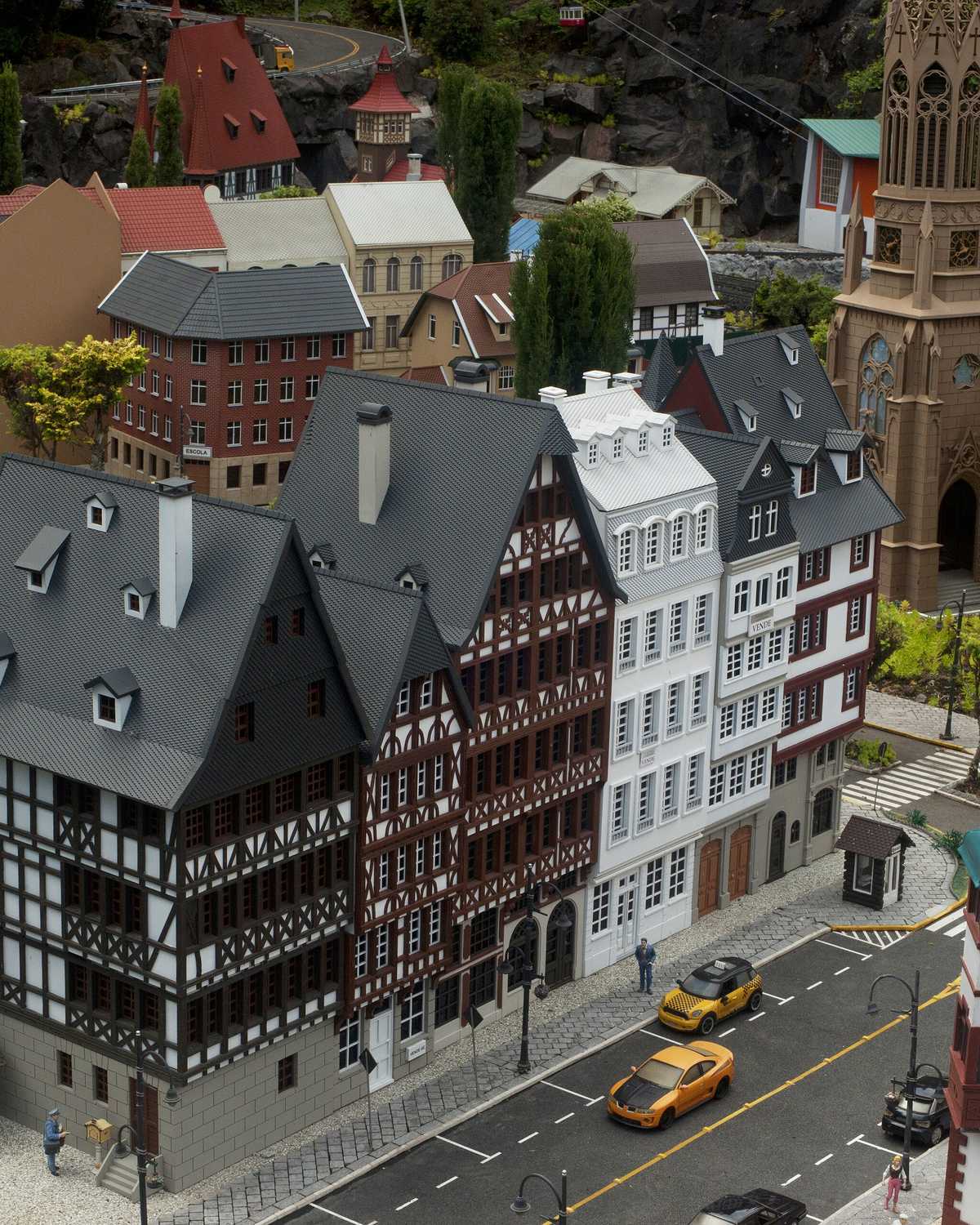 Cidade em miniatura do Mini Mundo, em Gramado, com casas enxaimel, uma igreja de torre alta, ruas e carrinhos em escala reduzida.